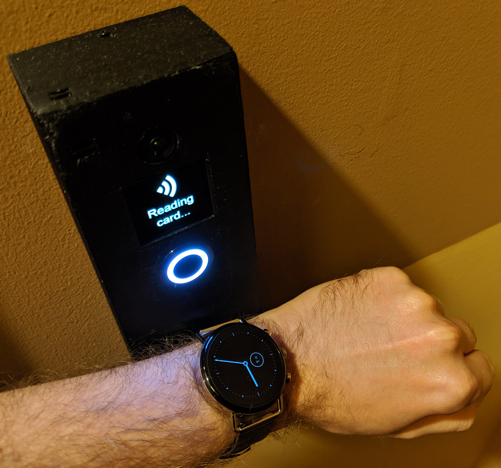 photo of watch being held to doorbell's NFC reader.  Screen reads "Reading card..."